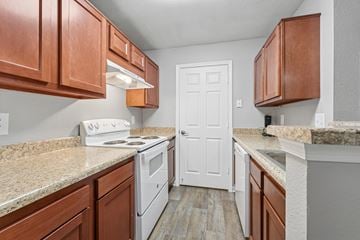 Woodbridge apartment for rent - A kitchen with white appliances and wooden cabinets.